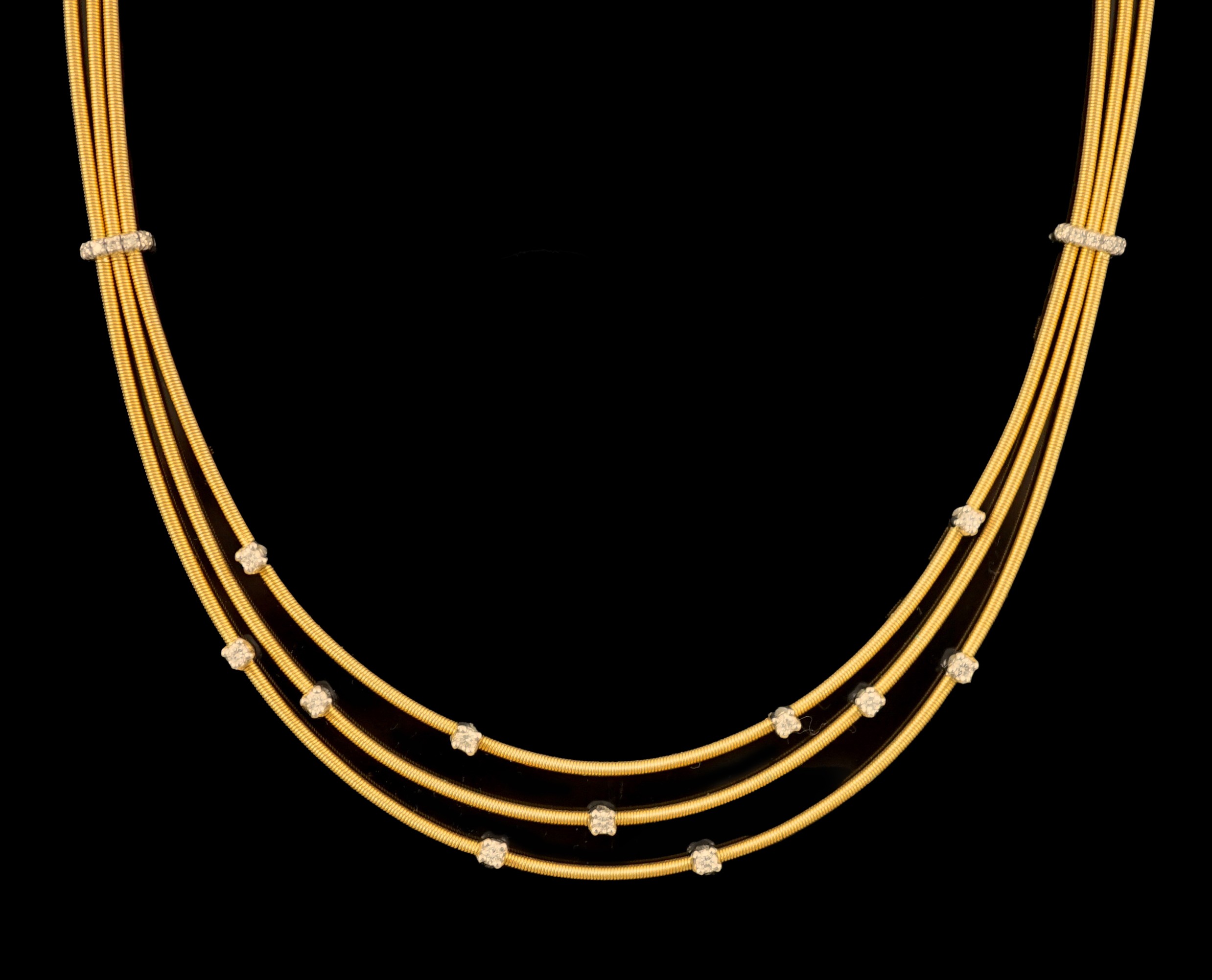 A modern Italian Marco Bicego 18ct gold and eleven stone diamond chip set triple strand necklace